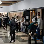 Oklahoma’s eviction process is being used as a form of rent collection, data shows Diverse adults waiting in a hospital corridor, some talking near doors and seating area under bright lights in a medical facility.