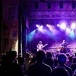 Norman Music Fest defined by feeling, haze, cross-genre range in 2026 Band performs on a lit stage with purple and blue lights as a crowd watches from the foreground at a nighttime concert.