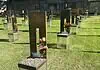 Oklahoma City remembers 31 years since Bombing with solemn focus Rows of bronze and metal grave markers with colorful flowers on a well-kept grassy cemetery lawn.