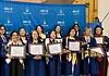 PRESS RELEASE: OKCPS Foundation celebrates 14 new Teacher Pipeline program graduates Group of graduates in blue gowns smiling and holding framed diplomas in front of a blue backdrop with OGE logos behind them.