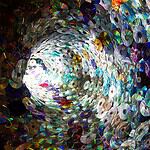 Spiral tunnel made of stacked compact discs reflecting rainbow colors