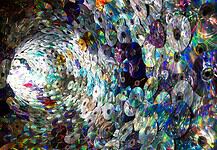 Spiral tunnel made of stacked compact discs reflecting rainbow colors