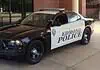 Suspect arrested in Arcadia Lake mass shooting; police chief speaks Two-tone Edmond Police patrol car (black and white) with a roof light bar, parked outside a brick building.