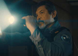 deadCenter features go heavy on history, diversity, modern battles Male officer in uniform shines a flashlight into a dim room, beam across the scene,