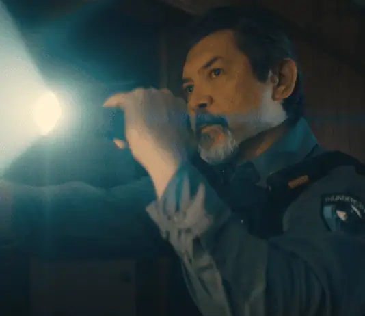 deadCenter features go heavy on history, diversity, modern battles Male officer in uniform shines a flashlight into a dim room, beam across the scene,