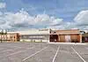PRESS RELEASE: Plans for MAPS 4 Mental Health Crisis Center approved Exterior view of the OKC Crisis Center with a brick and tan facade and a spacious parking lot in the foreground, daytime with people walking nearby.