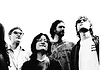 Mad Honey build alt-rock landmark on ‘Bridge Over Cumberland’ Five-person rock band standing side by side, looking up, in a black-and-white photo.