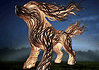 PRESS RELEASE: Name the dog sculpture at the OKC Louisa McCune Animal Welfare Center Abstract wooden horse sculpture made of twisting carved planks, lit against a dark night sky in a foggy field.”