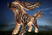 PRESS RELEASE: Name the dog sculpture at the OKC Louisa McCune Animal Welfare Center Abstract wooden horse sculpture made of twisting carved planks, lit against a dark night sky in a foggy field.”