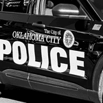 OKC man dies after calling police to report being shot miles away Black-and-white photo of an Oklahoma City Police Department patrol car with large POLICE lettering on the side.