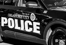 Shooting death rocks NW OKC apartment complex; no arrests yet Black-and-white photo of an Oklahoma City Police Department patrol car with large POLICE lettering on the side.