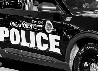 OKC man dies after calling police to report being shot miles away Black-and-white photo of an Oklahoma City Police Department patrol car with large POLICE lettering on the side.