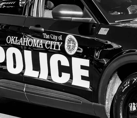 Shooting death rocks NW OKC apartment complex; no arrests yet Black-and-white photo of an Oklahoma City Police Department patrol car with large POLICE lettering on the side.