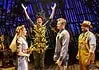 Country comedy ‘Shucked’ a corn-fed good time at Civic Center Actor in a leafy, harvest-themed costume raises arms on stage as four costumed performers look on with smiles on a wooden theater set.