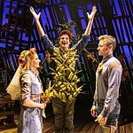 Country comedy ‘Shucked’ a corn-fed good time at Civic Center Actor in a leafy, harvest-themed costume raises arms on stage as four costumed performers look on with smiles on a wooden theater set.