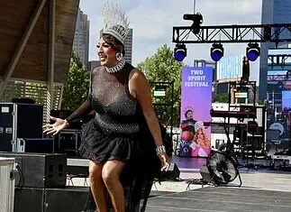 PrideFest 2026 kicks off with joy, community at Scissortail Park Drag performer wearing a tall silver crown and black sequined outfit performing on an outdoor stage at the Two Spirit Festival
