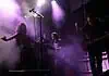 Crank up the summer with these hard-driving rock and metal shows Live music performance on a foggy stage with purple lighting; female singer left, keyboardist center, guitarist right.