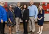 PRESS RELEASE: OCCC TRIO program honored nationally for advancing student success Six diverse professionals pose for a group photo in an office lobby with a red panel wall behind them.