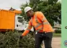 PRESS RELEASE: June storm debris to be collected in OKC on regular July bulky waste schedule Utility worker in an orange safety vest and hard hat clearing storm debris beside a city dump truck; green panel on the right reads 'UPDATE June Storm Debris Collection' with city seal.
