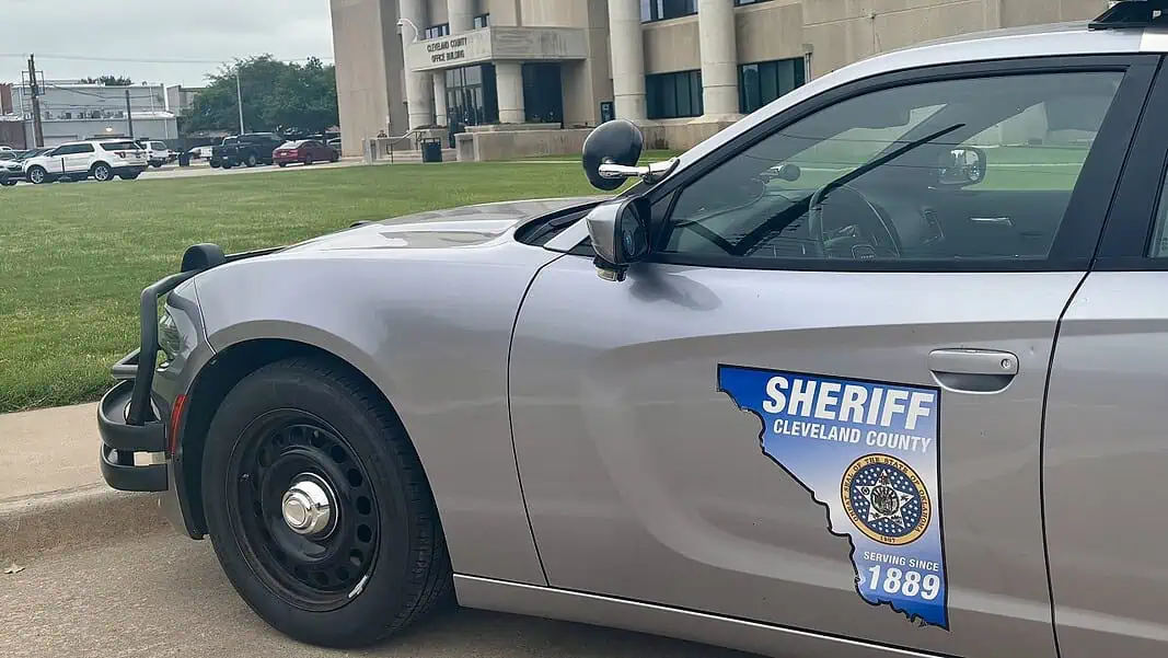 Photo Jun 12 2026, 11 25 19 AM Side of a silver sheriff patrol car with a Cleveland County badge and an Ohio-shaped decal reading 'Serving since 1889'.