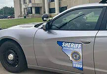 Acting Cleveland Co. sheriff calls for special election, FBI review Side of a silver sheriff patrol car with a Cleveland County badge and an Ohio-shaped decal reading 'Serving since 1889'.