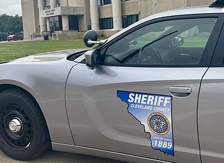 Acting Cleveland Co. sheriff calls for special election, FBI review Side of a silver sheriff patrol car with a Cleveland County badge and an Ohio-shaped decal reading 'Serving since 1889'.