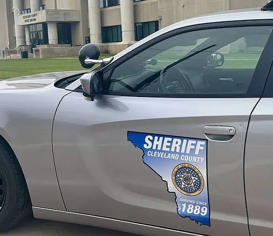 Acting Cleveland Co. sheriff calls for special election, FBI review Side of a silver sheriff patrol car with a Cleveland County badge and an Ohio-shaped decal reading 'Serving since 1889'.