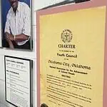 Freedom Center unveils restoration with ‘Inside These Walls’ exhibition Wall exhibit with four large portraits of diverse adults, plus a yellow CHARTER poster labeled 'Youth Council' on a pink mat, and a framed council advisory list nearby, in a museum-like setting.