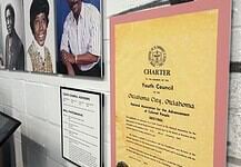 Freedom Center unveils restoration with ‘Inside These Walls’ exhibition Wall exhibit with four large portraits of diverse adults, plus a yellow CHARTER poster labeled 'Youth Council' on a pink mat, and a framed council advisory list nearby, in a museum-like setting.