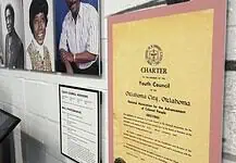Freedom Center unveils restoration with ‘Inside These Walls’ exhibition Wall exhibit with four large portraits of diverse adults, plus a yellow CHARTER poster labeled 'Youth Council' on a pink mat, and a framed council advisory list nearby, in a museum-like setting.