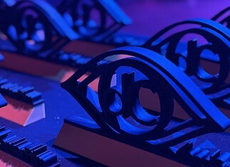 Here are the award winners of the 2026 deadCenter Film Festival! Close-up of ornate black metal eye-shaped sculptures resting on a keyboard, lit in blue and purple stage lighting.