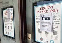 On eve of adoption drive, City rescues over 500 animals in drug bust A door with a large posting labeled 'URGENT INTAKE ONLY' and a smaller 'NOTICE' sign attached over the poster.