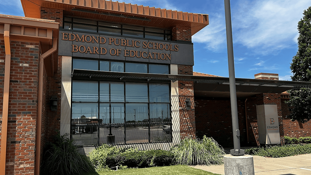 Edmond Schools 2 Edmond Public Schools Board of Education building with brick exterior and large windows under a blue sky