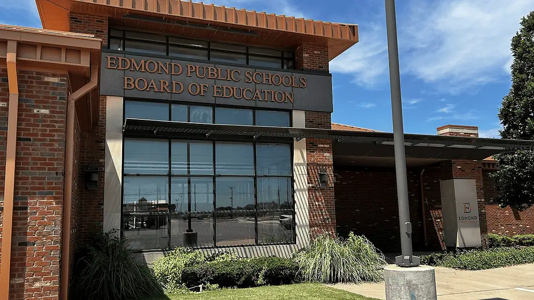 Edmond Schools 2 Edmond Public Schools Board of Education building with brick exterior and large windows under a blue sky