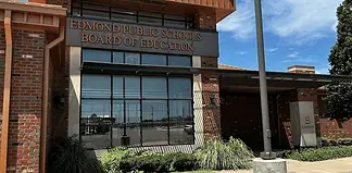 Edmond Public Schools Board of Education building with brick exterior and large windows under a blue sky