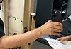 Oklahoma County bail hearings don’t meet constitutional standards, attorneys say Person in a black shirt holds a smartphone to photograph printed papers being handed to them near a rusty metal door.