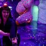 Factory Obscura’s RECORD+PLAY adds new layers of interaction to Mix-Tape Two people hug and smile in a neon-lit, immersive art space with colorful glowing sculptures behind them, purple lighting everywhere.