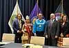 PRESS RELEASE: Five Tribes call for oversight of prediction markets Six people in formal attire stand on a stage with colorful banners and flags behind them, posing for a group photo.