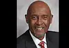 PRESS RELEASE: OKC honors the life of M.T. Berry, first Black police chief Professional headshot of a smiling Black man in a dark pinstripe suit and red patterned tie, against a gray backdrop.