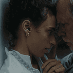 Hypnotic, unsettling ‘Night Nurse’ a piercing portrait of sociopathy Young woman and an older man press foreheads together in a tender, intimate moment beside a wall.