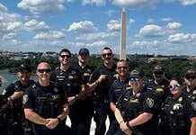 OKC police in DC: Dept says no concern or cost to public at home Group of police officers posing for a photo on a boat or dock with the Washington Monument in the background along the Potomac River