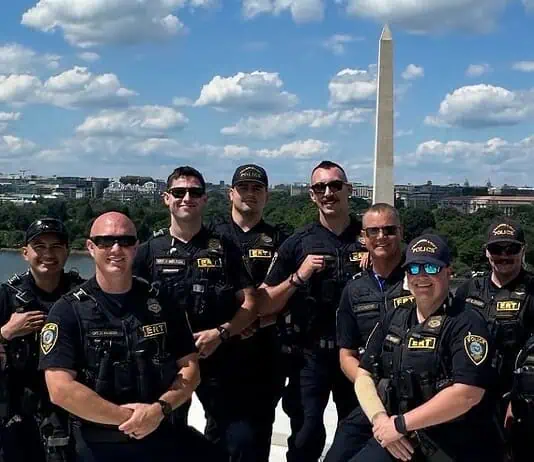 OKC police in DC: Dept says no concern or cost to public at home Group of police officers posing for a photo on a boat or dock with the Washington Monument in the background along the Potomac River