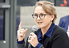 Paula Lewis resigns from Oklahoma City school board after historic tenure Woman with glasses speaking into a microphone during a panel discussion in a conference setting.
