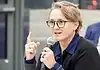 Paula Lewis resigns from Oklahoma City school board after historic tenure Woman with glasses speaking into a microphone during a panel discussion in a conference setting.