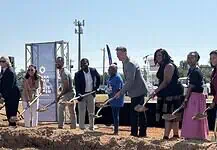 Clara Luper Civil Rights Center celebrates long-awaited groundbreaking Diverse group at a groundbreaking ceremony, each person with a shovel poised to dig on a dirt mound, banners in background.