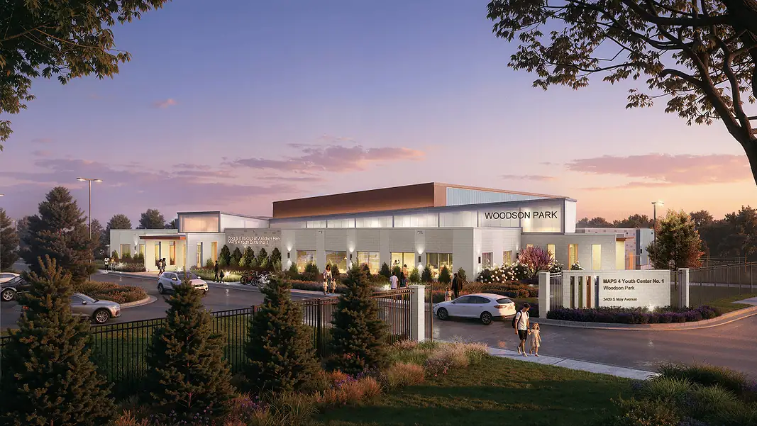 Woodson Park Youth Center MAPS Exterior view of the Woodson Park community center at sunset, with cars parked and people walking toward a landscaped entrance.