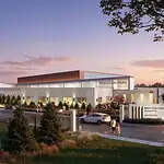 PRESS RELEASE: Final plans approved for first MAPS 4 Youth Center in Woodson Park Exterior view of the Woodson Park community center at sunset, with cars parked and people walking toward a landscaped entrance.