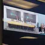 State executes longtime death row inmate convicted in OKC murder Split-screen video conference of a government meeting: left panel shows officials at a long table with flags in an Oklahoma setting; right panel shows three women, one signing, at a different location.