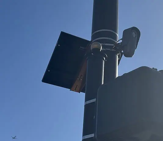 City to vote on sweeping ‘guardrails’ for Flock cameras as OKCPD continues use Streetlight pole with a solar panel, security camera, and large control box against a blue sky.